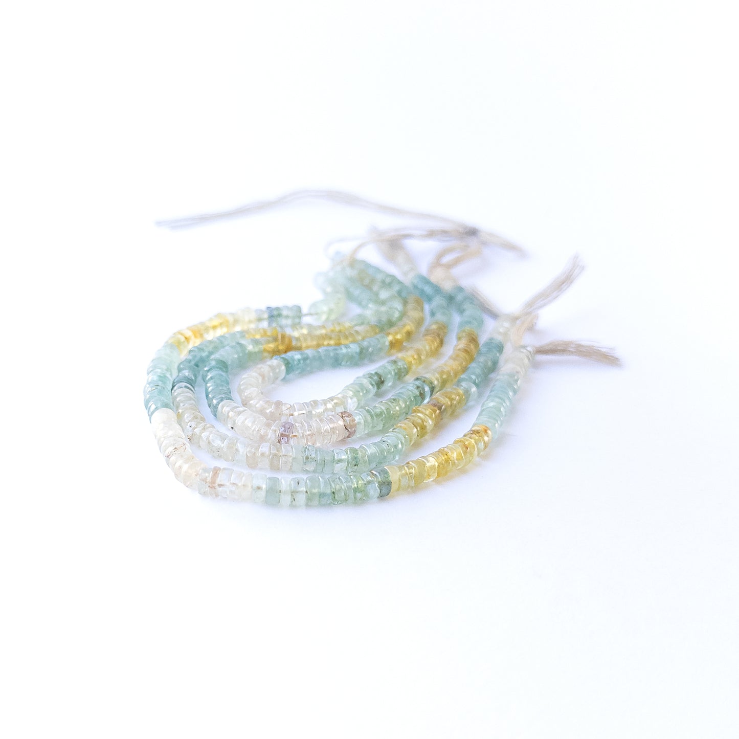 Multi Aquamarine smooth wheels displaying soft blue hues and premium craftsmanship in a 22cm strand.