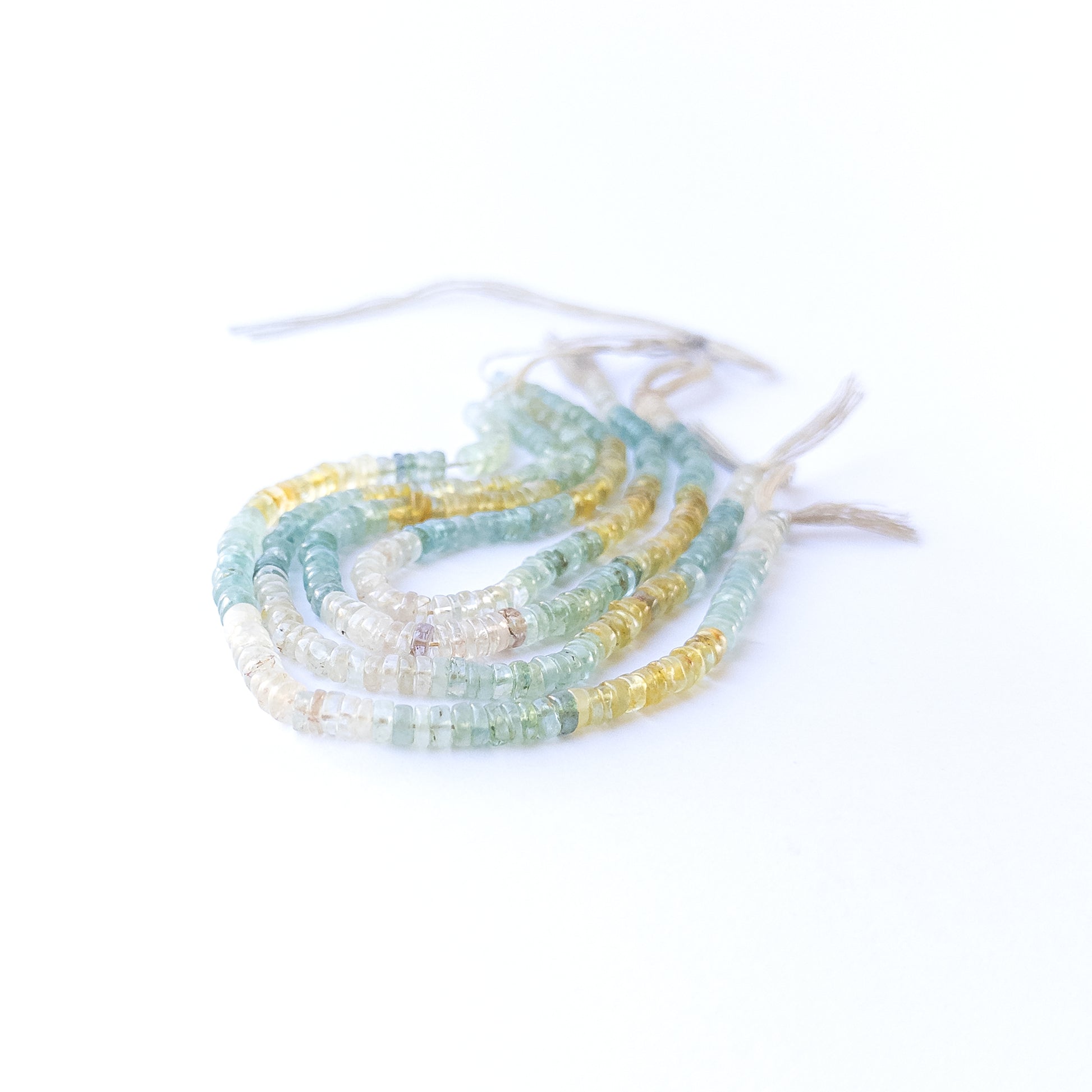 Multi Aquamarine smooth wheels displaying soft blue hues and premium craftsmanship in a 22cm strand.