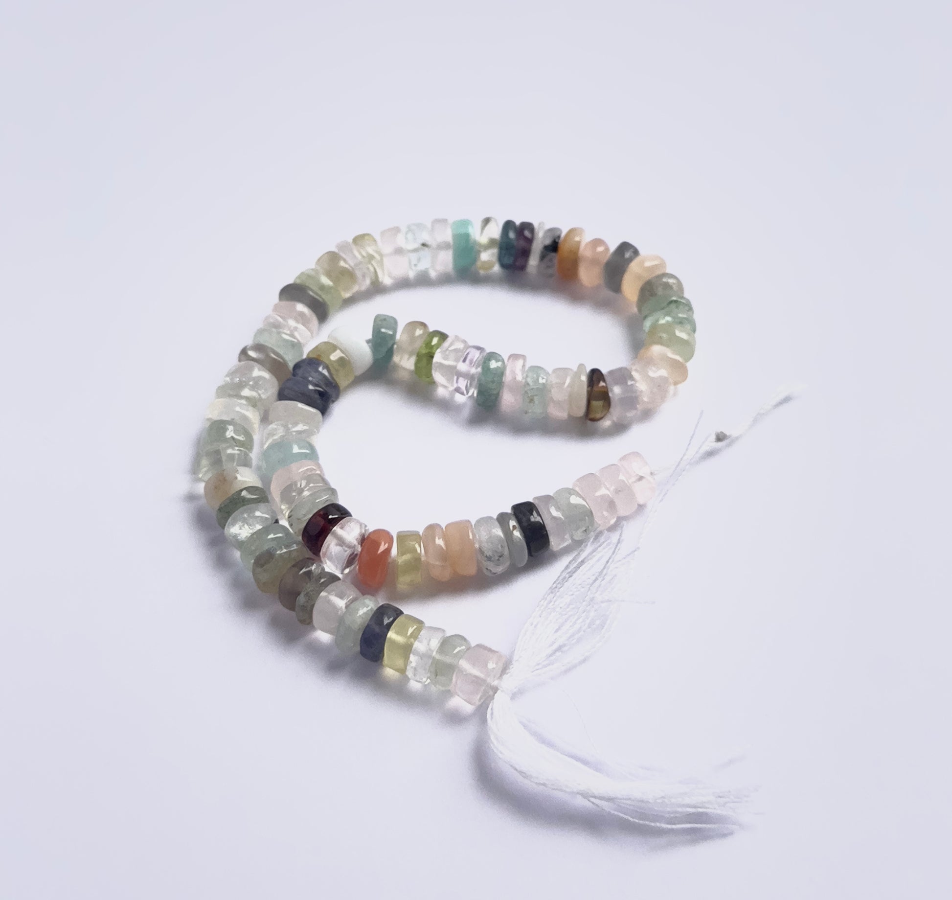 Handmade jewellery components featuring Multi Disco smooth wheel beads strung neatly together.