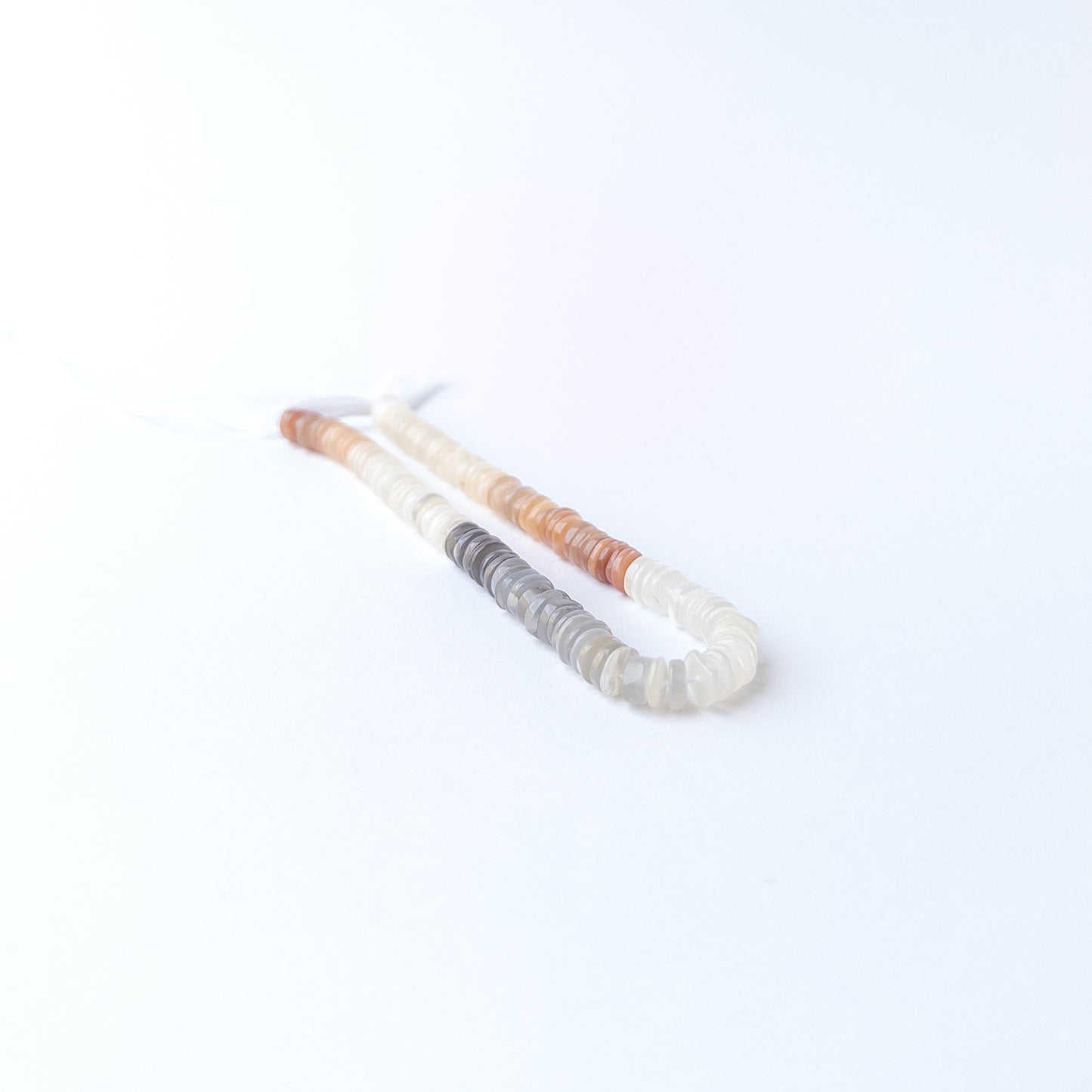 Multi Moonstone smooth wheel gemstone beads in soft neutral tones, ideal for genuine stone bead jewellery making.