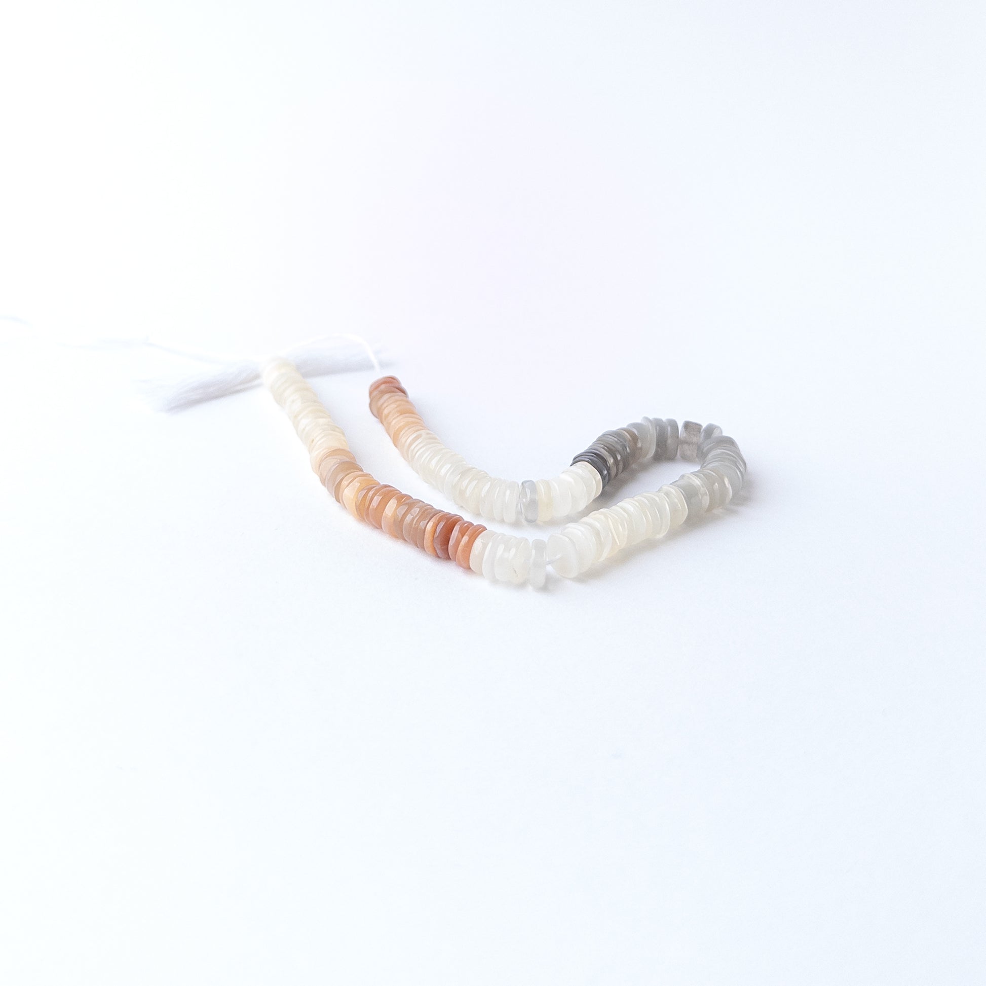 Genuine Multi Moonstone stone beads arranged in a 20cm strand, showcasing subtle sheen and smooth wheel shaping.