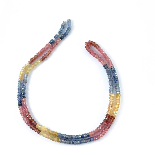 Multi Precious faceted rondelle stone beads in ruby, yellow sapphire and blue sapphire showing bright colour and sparkle.