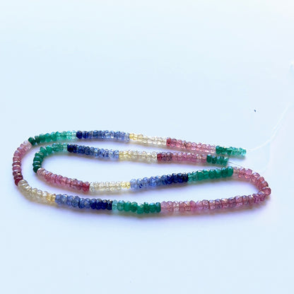 Multi‑precious faceted rondelle strand with ruby, yellow sapphire, blue sapphire and emerald 3.3–4mm, 39cm, 56 carats.
