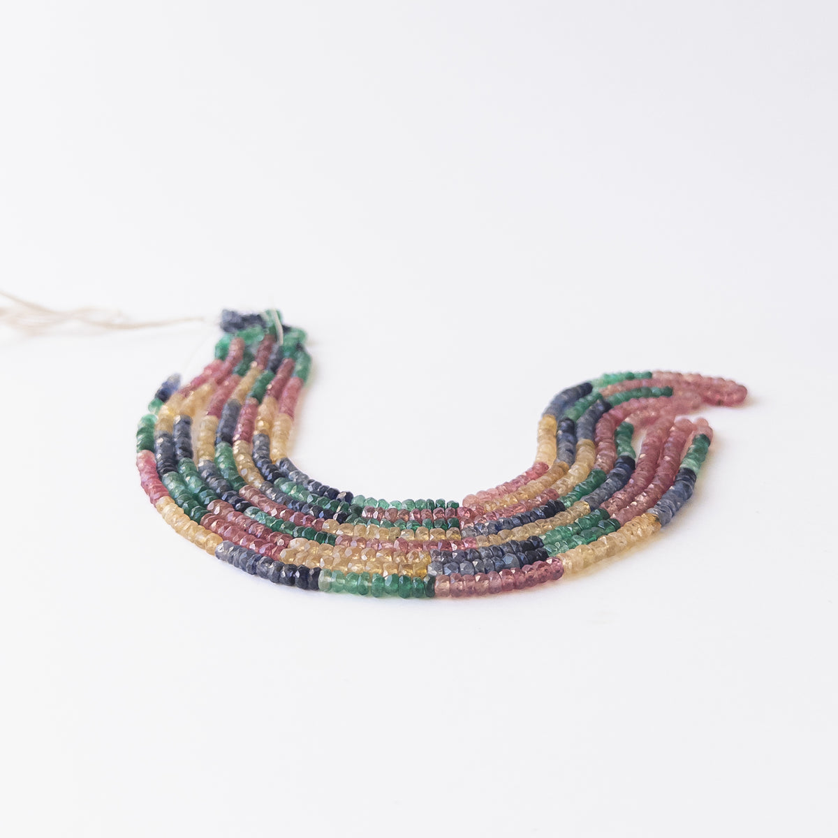 Authentic Multi Precious gemstone beads displaying assorted hues and polished faceted shine.