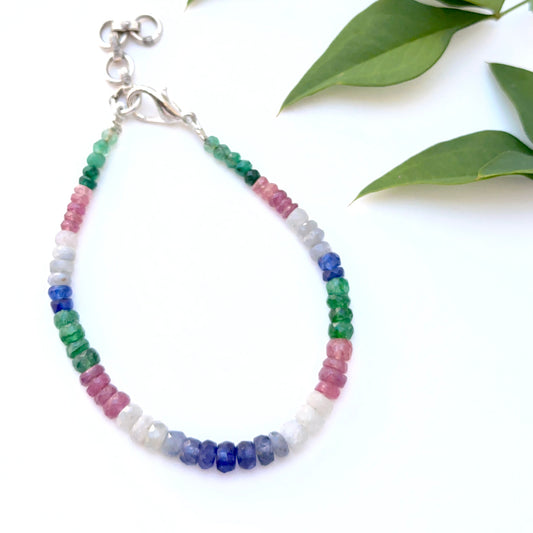 Multi precious bracelet featuring faceted rondelle beads in ruby, emerald and sapphire.