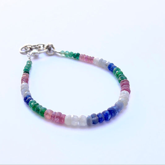 Close‑up of sparkling faceted gemstone beads arranged on a finished bracelet.