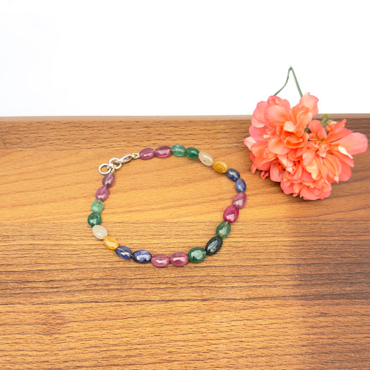 Close-up of multi precious bracelet with polished oval beads in vibrant jewel tones.
