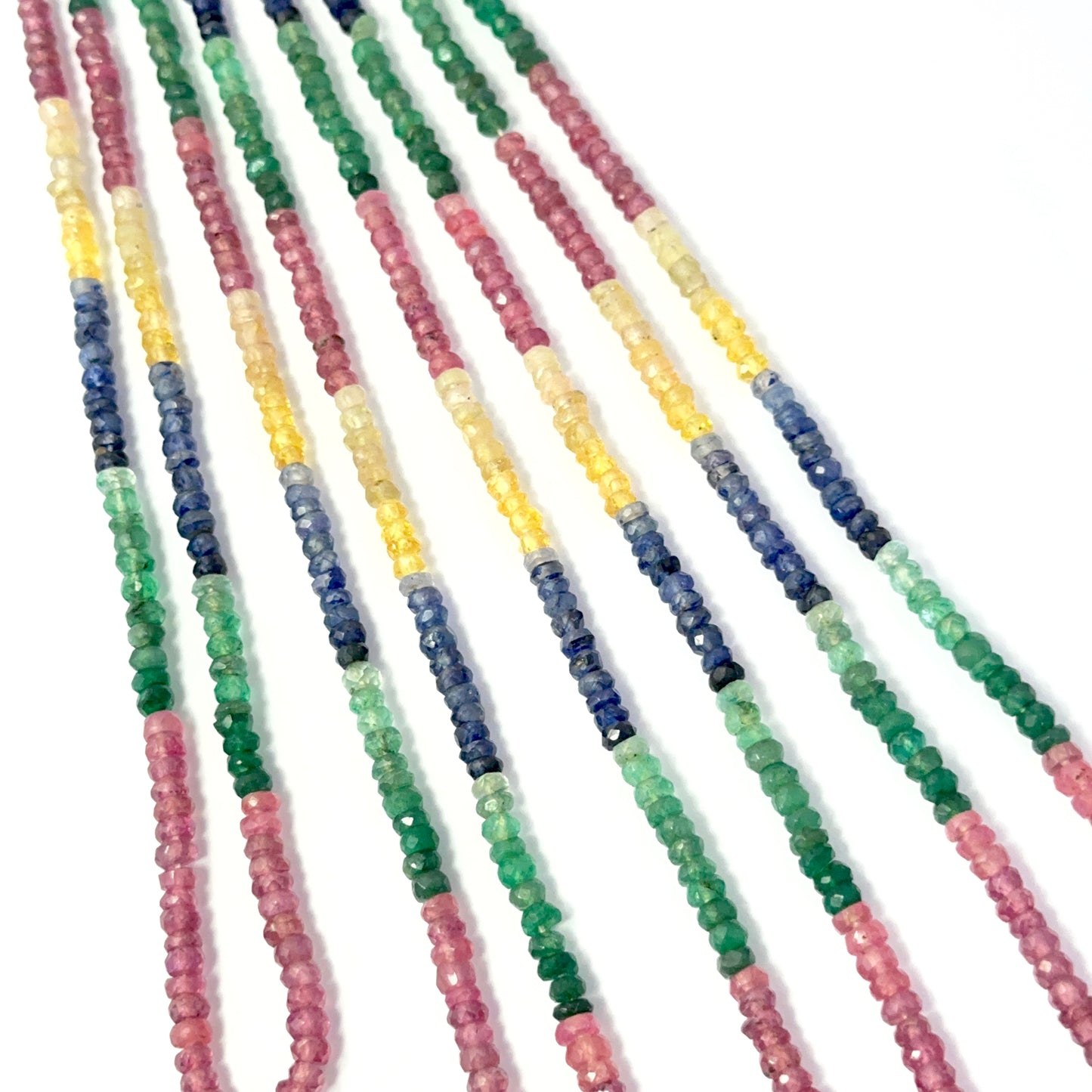 Close view of ruby, blue sapphire, yellow sapphire and emerald faceted rondelles on a 39cm strand for handmade jewellery components.