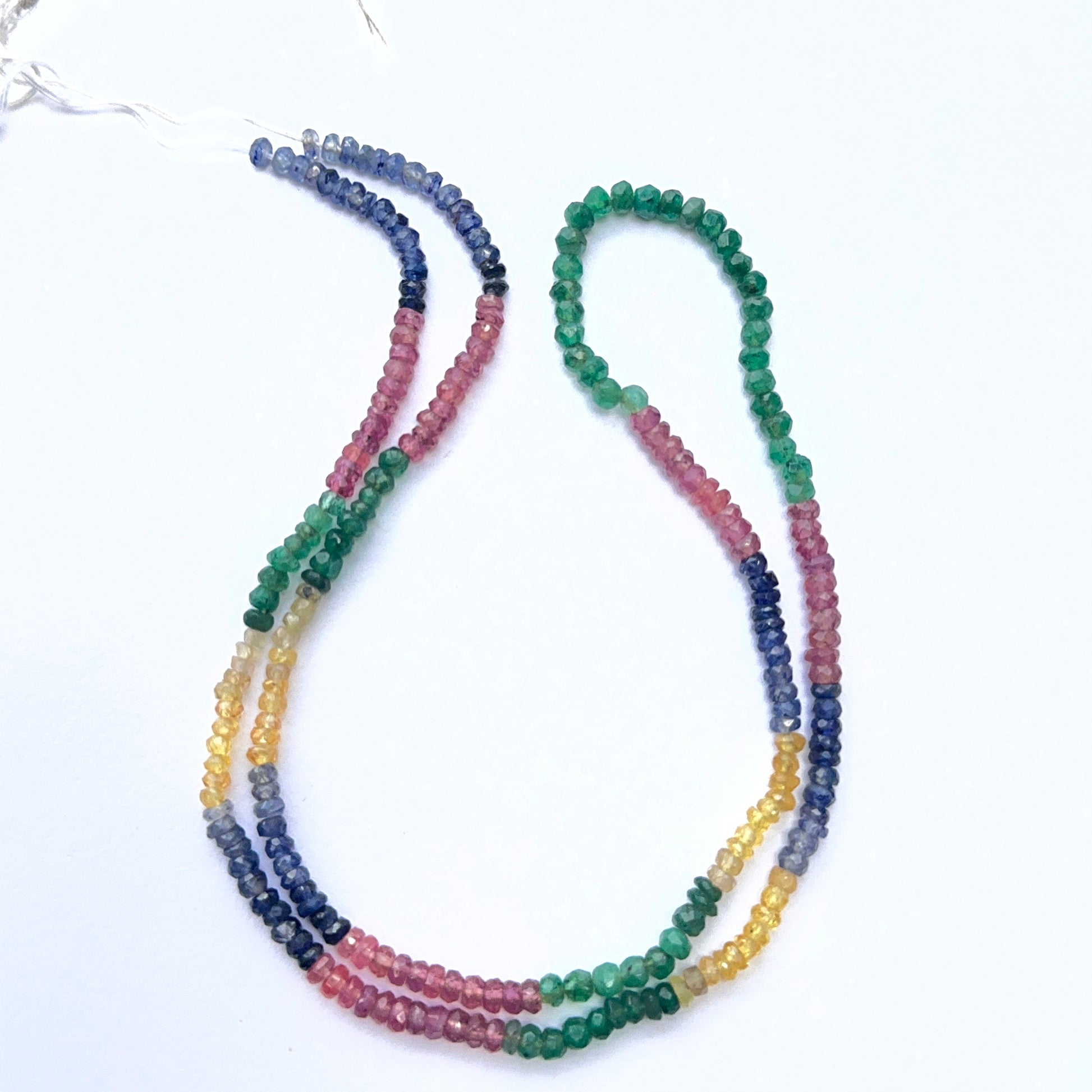 Multi gemstone strand with faceted rondelle beads in ruby, emerald, blue and yellow sapphire.