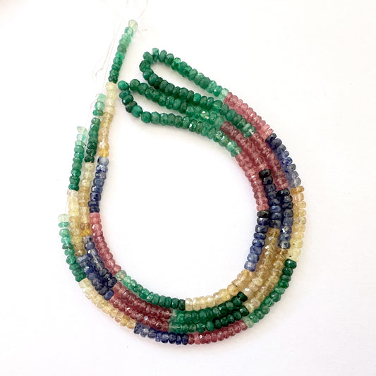 Close-up of 3.5-4mm Multi Precious gemstone beads arranged on a 41cm strand with precision faceting.
