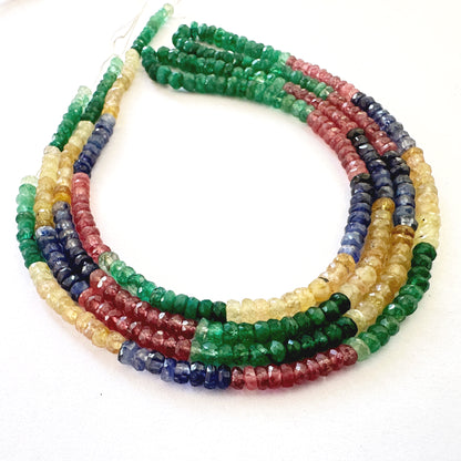 Colourful rondelle gemstones with faceted cuts sparkle under light, displaying premium polish and clarity.