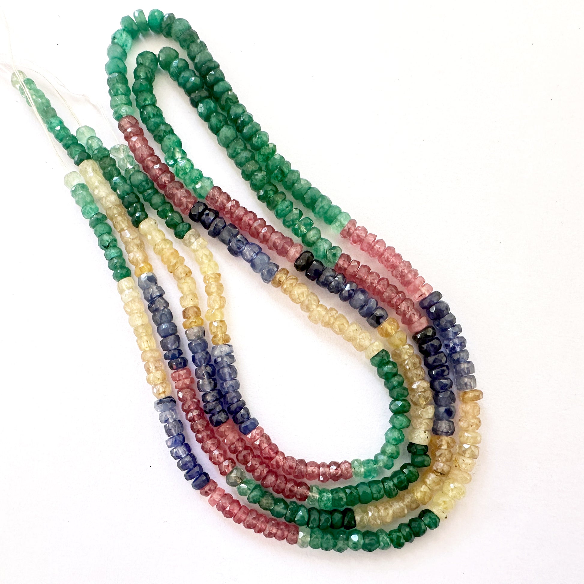Strand of Multi Precious beads showcasing the variety of hues and meticulous faceted craftsmanship.