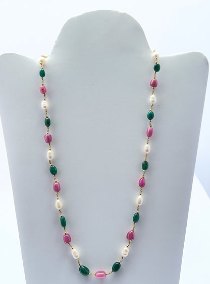 Multi precious necklace featuring smooth tumble ruby, emerald and pearl beads in a vibrant design.