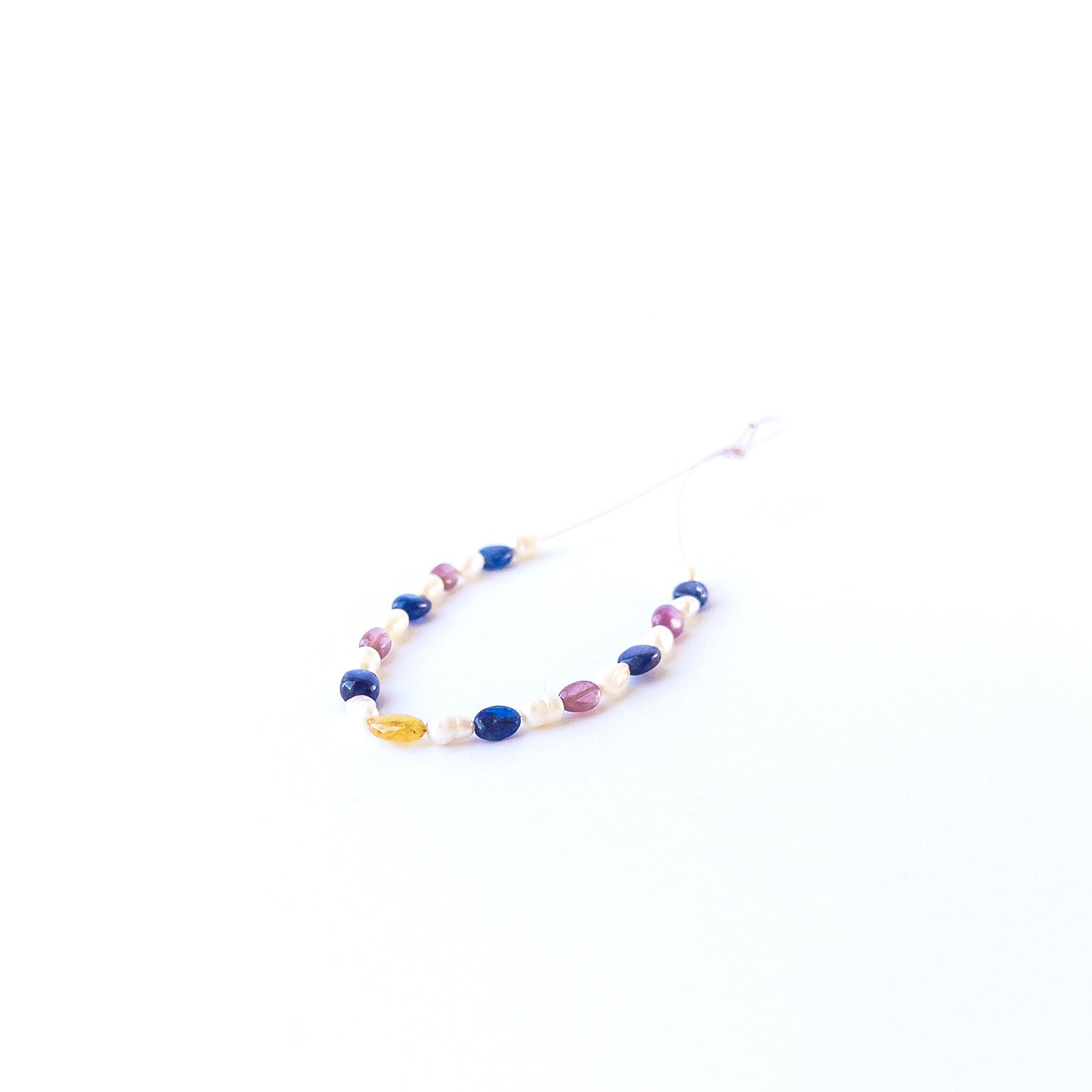 Genuine multi precious gemstone beads and freshwater pearls in smooth oval cut arranged in a 23‑piece set.