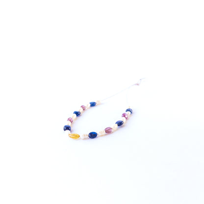 Genuine multi precious gemstone beads and freshwater pearls in smooth oval cut arranged in a 23‑piece set.