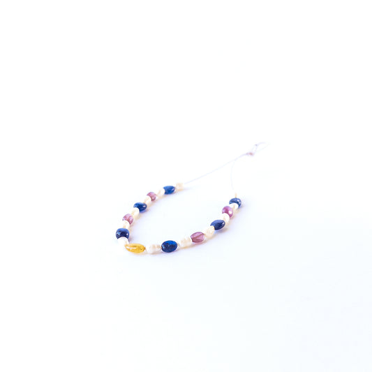 Genuine multi precious gemstone beads and freshwater pearls in smooth oval cut arranged in a 23‑piece set.