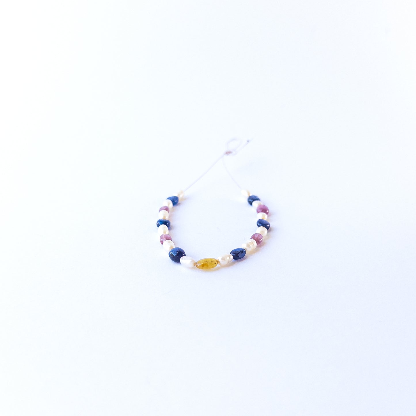Multi precious oval beads and pearls showcasing polished surfaces and elegant colour contrast.