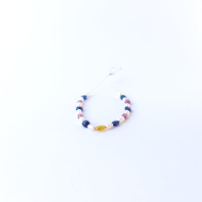 Multi precious oval beads and pearls showcasing polished surfaces and elegant colour contrast.