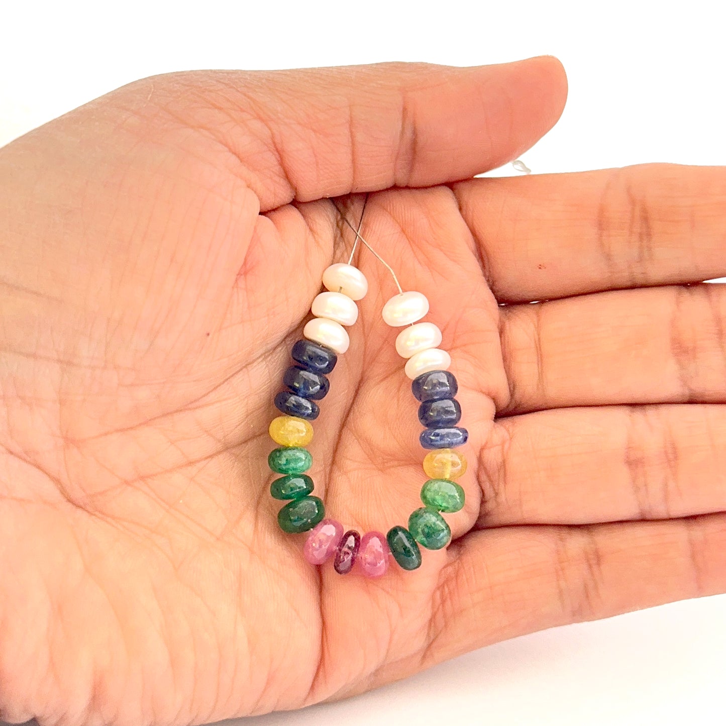 Close‑up of smooth rondelle freshwater pearls and multi precious beads 6.2–6.7mm showing polished surfaces and soft sheen.