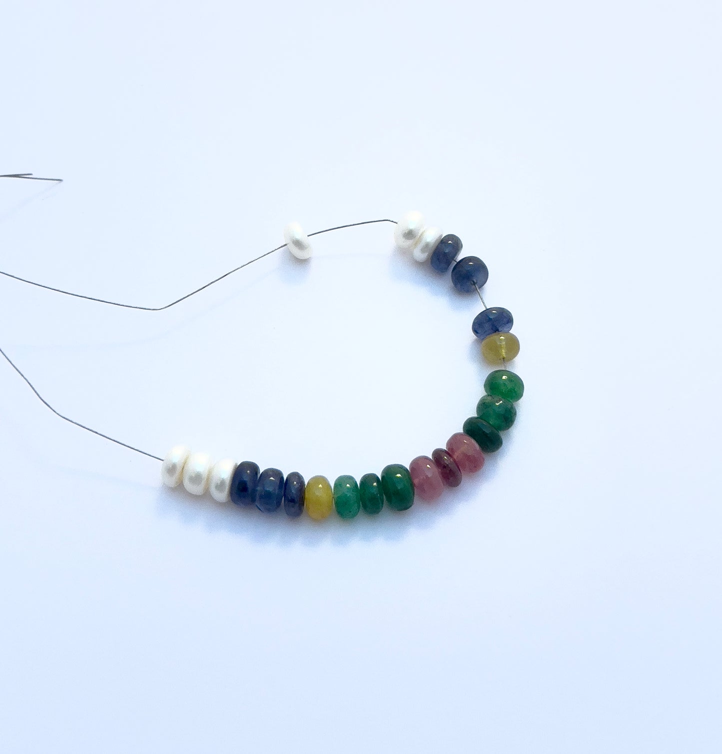 Detailed view of multi-precious bracelet with ruby, emerald, sapphire, and pearl beads totalling 35 carats.