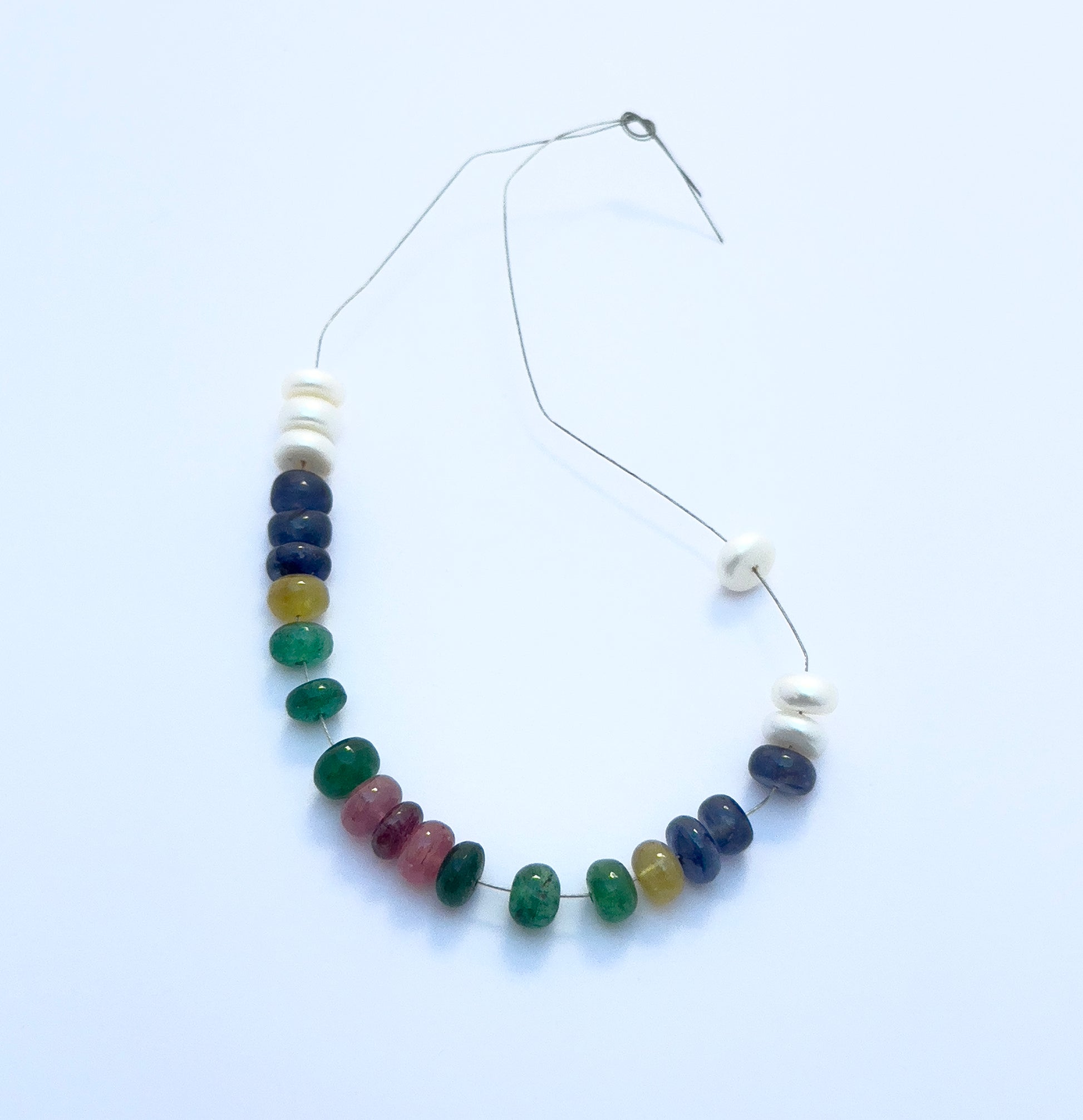 Handcrafted gemstone bracelet showcasing polished rondelle beads in vibrant colours and lustrous pearls. 