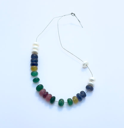 Handcrafted gemstone bracelet showcasing polished rondelle beads in vibrant colours and lustrous pearls. 