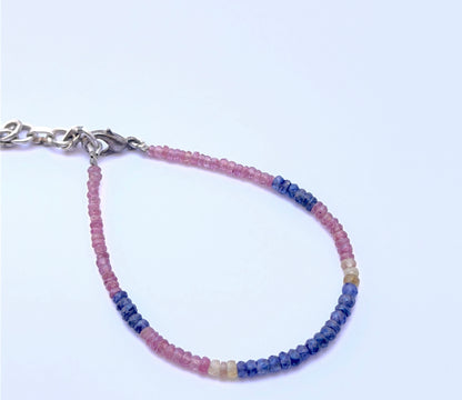 Gemstone bracelet with faceted beads arranged in a smooth design.