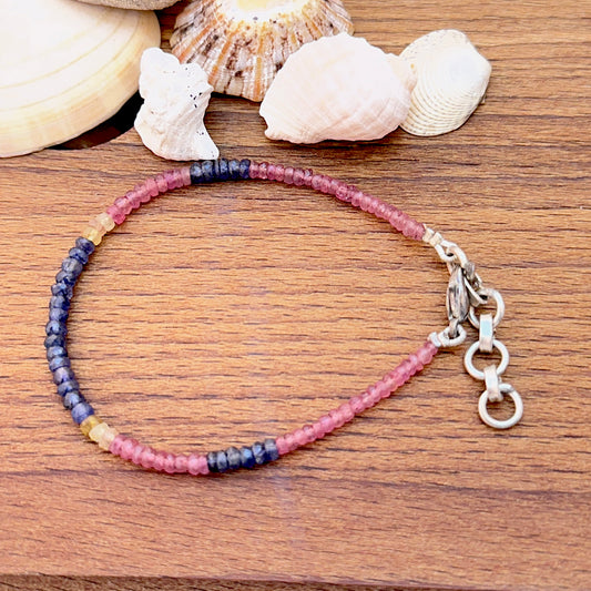 Gemstone bracelet with faceted rondelles showing bright multi‑colour shine.