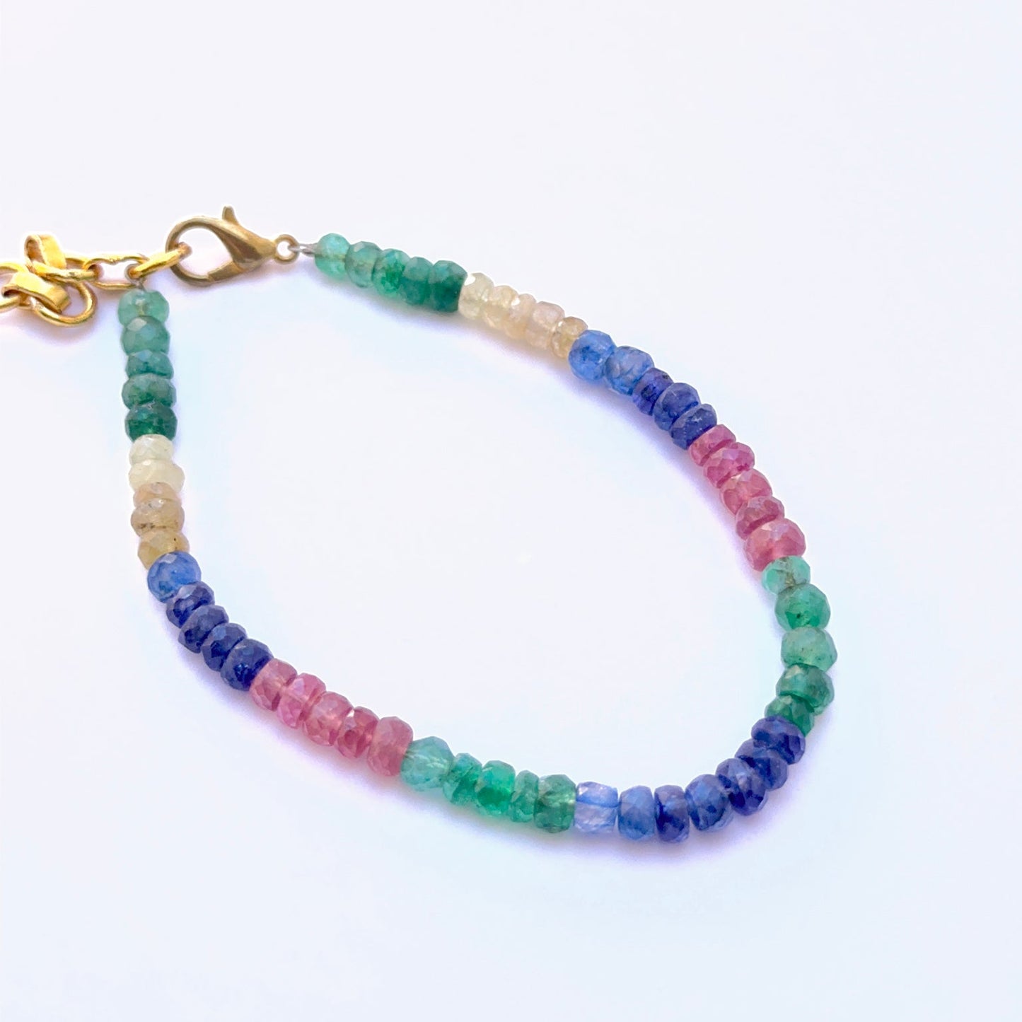 Gemstone bracelet with faceted beads showing bright multi‑colour shine.