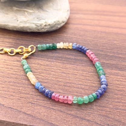 Multi precious bracelet featuring faceted rondelle beads in ruby, emerald, sapphire and yellow sapphire.