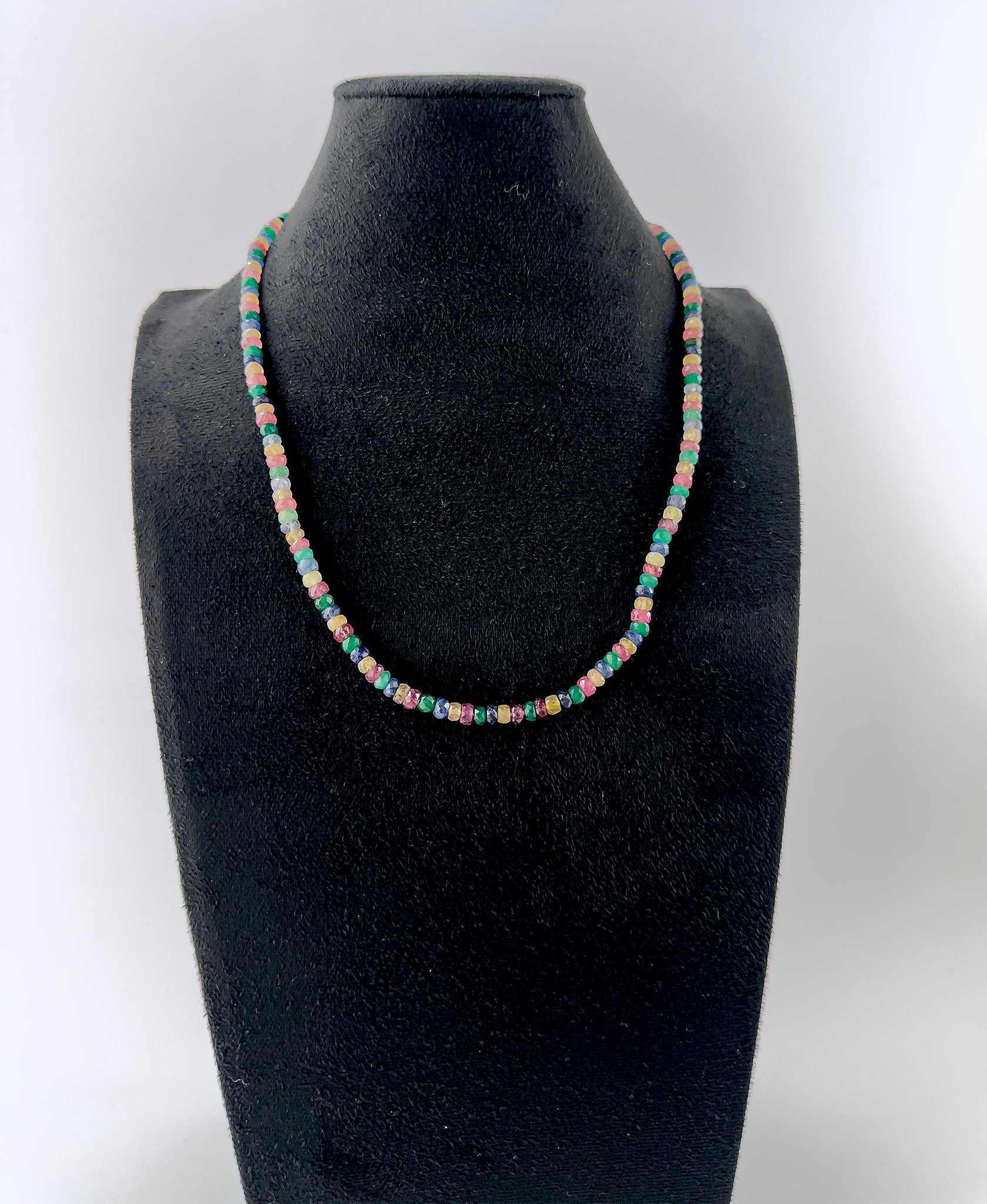 Handcrafted necklace combining Ruby, Emerald, Blue Sapphire and Yellow Sapphire gemstone beads in a polished faceted rondelle cut.
