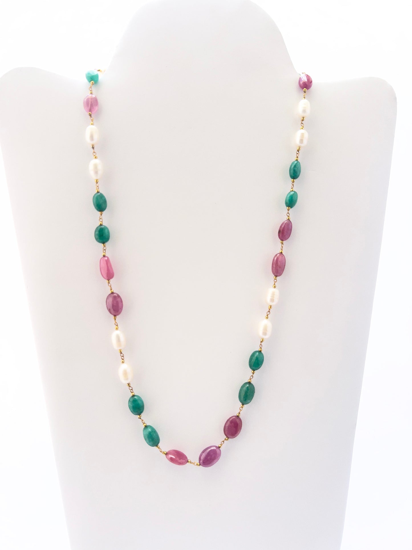 Necklace combining freshwater pearls, emeralds, and rubies in smooth oval beads, radiant gemstone mix.