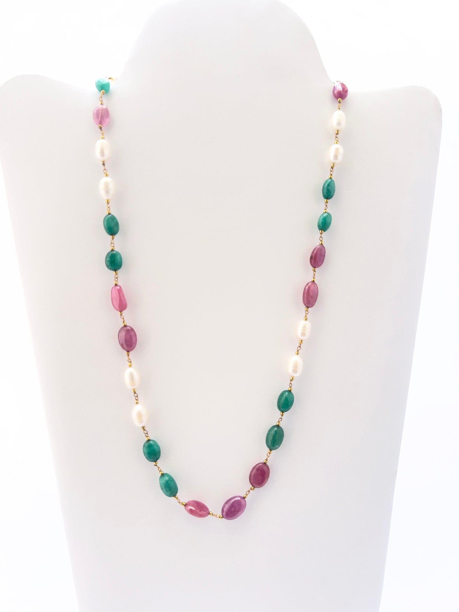 Necklace combining freshwater pearls, emeralds, and rubies in smooth oval beads, radiant gemstone mix.