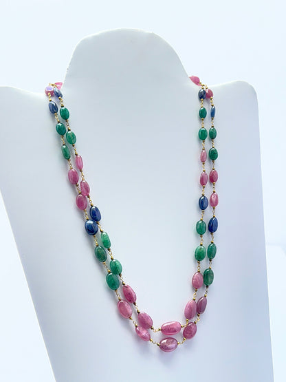 Emerald, ruby and sapphire necklace with smooth oval beads showing rich colour.