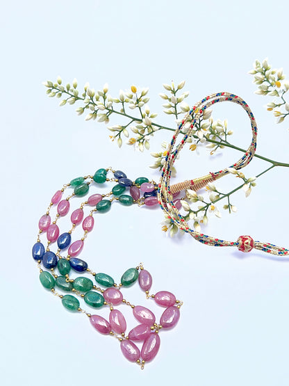 Elegant gemstone necklace featuring polished oval beads in a vibrant tri‑colour design.
