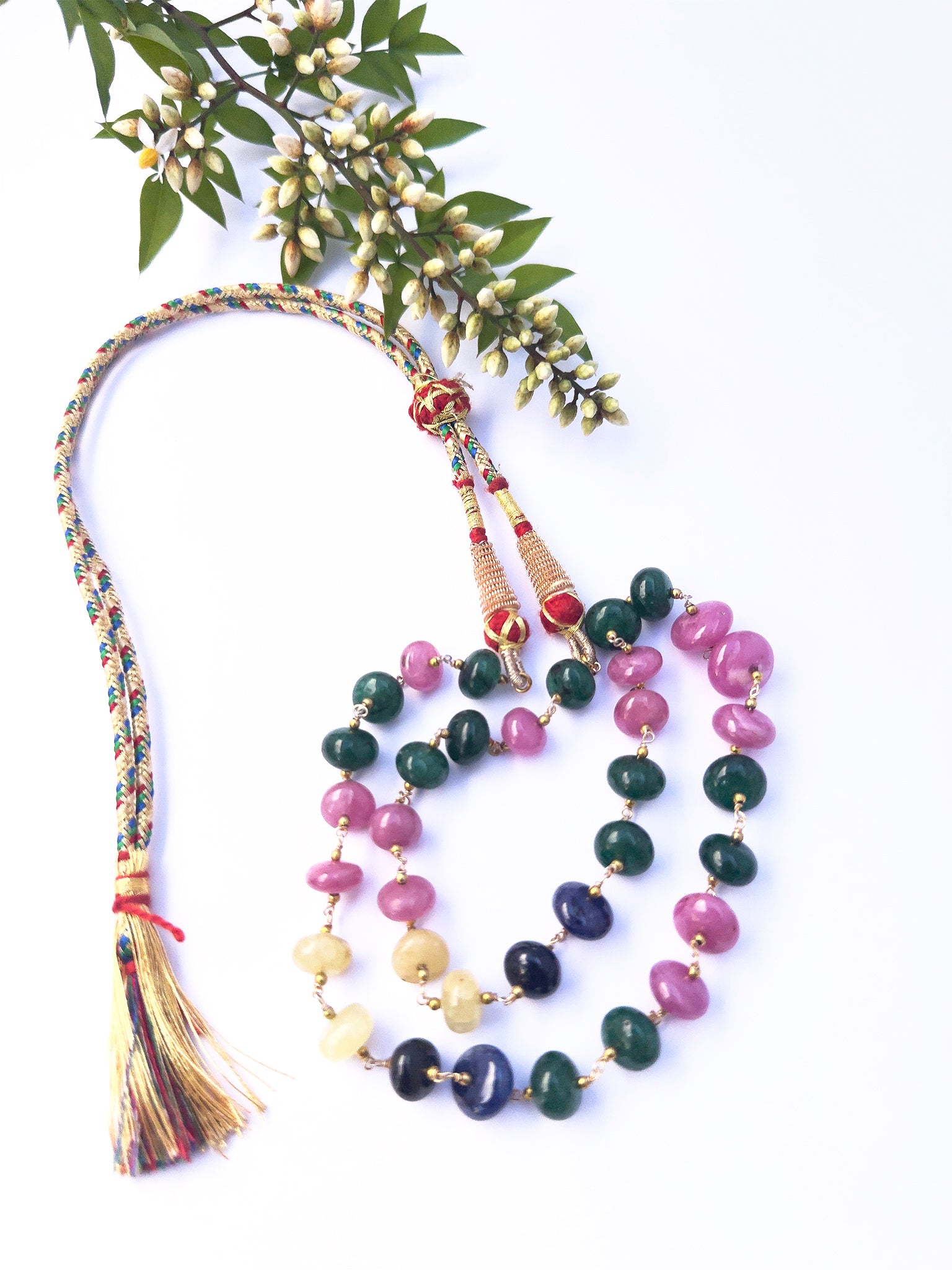 Single strand necklace showcasing deep red Ruby, lush green Emerald, and sparkling sapphires.