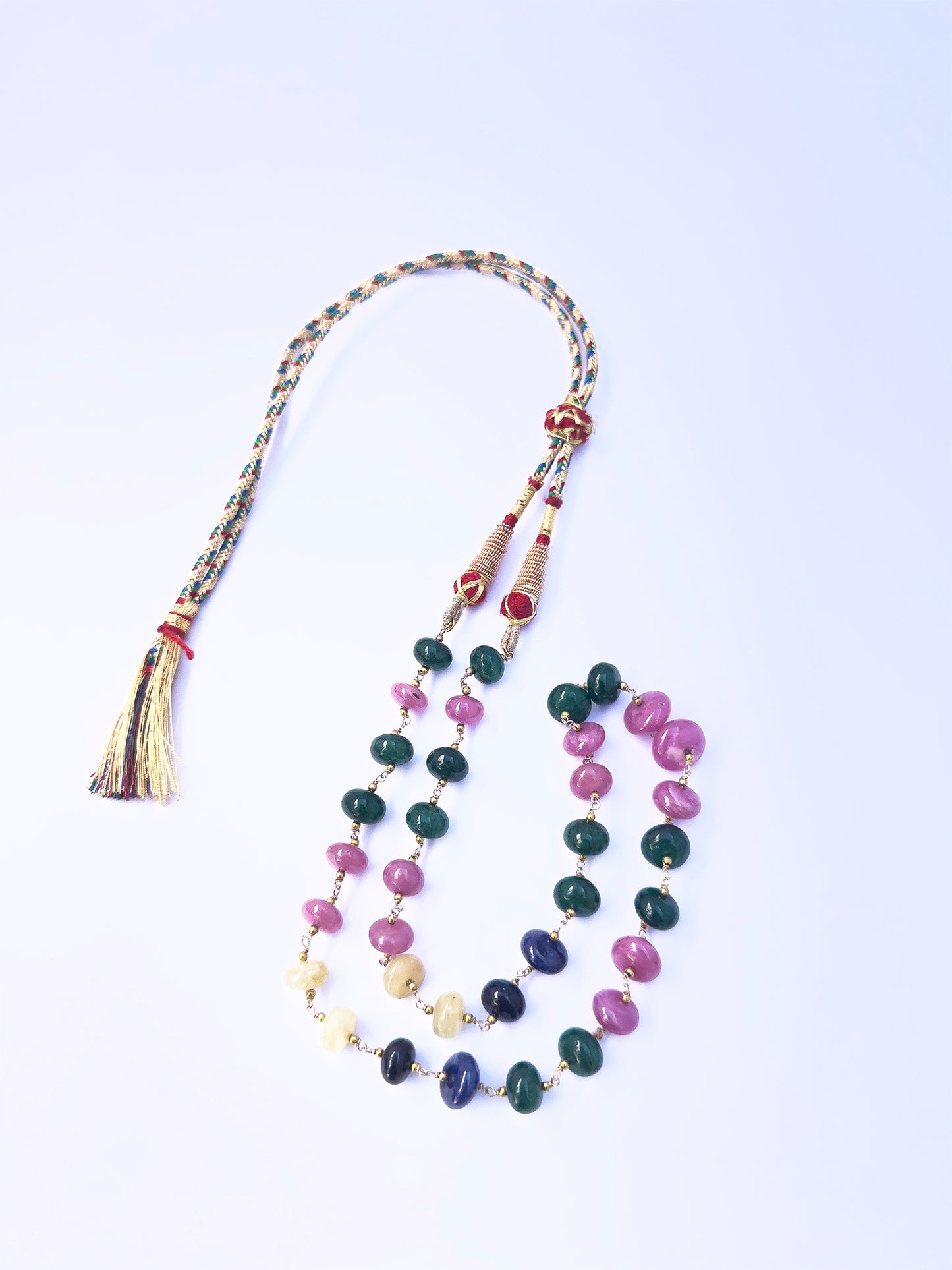 Detailed view of multi precious rondelle beads, polished finish, vibrant gemstone colours.