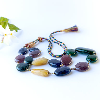 Close up of Multi Precious gemstone beads showing polished surfaces and bold colour variety for crafting projects.