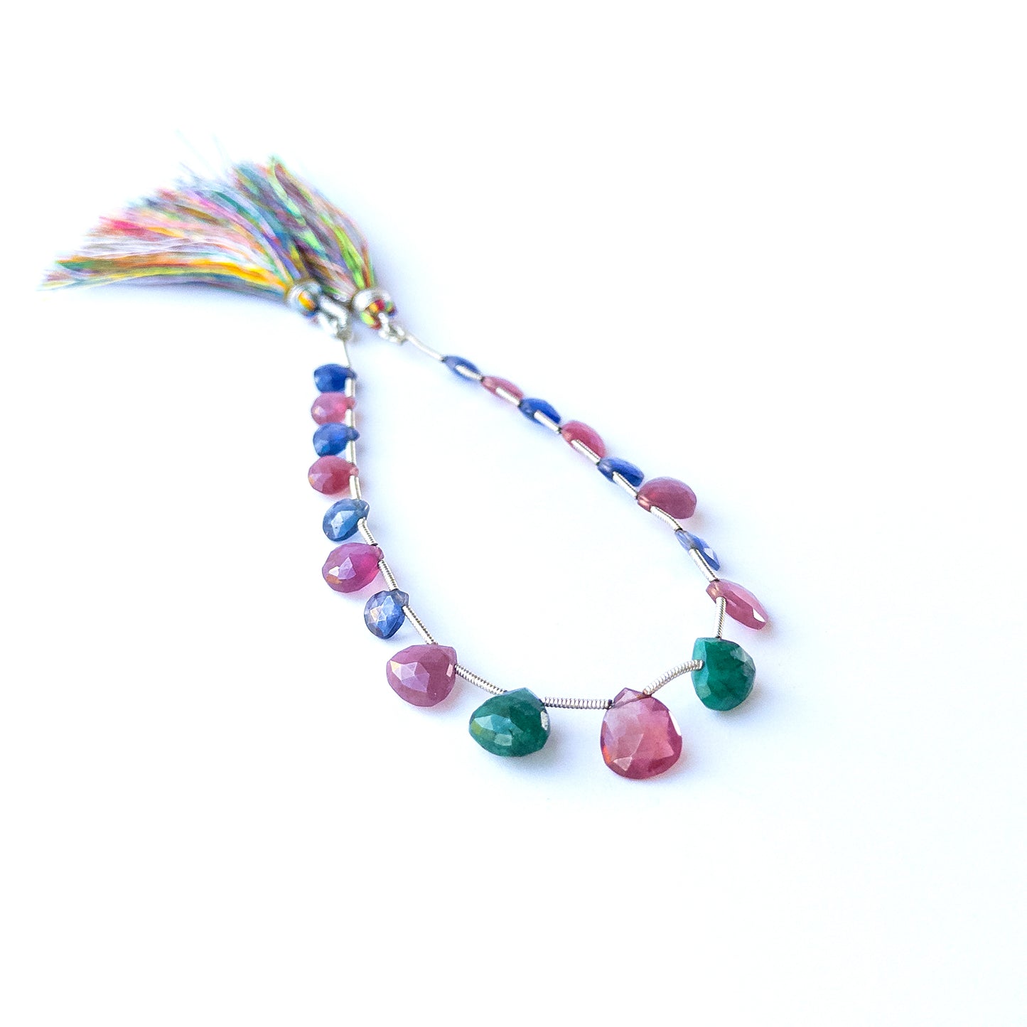 Vibrant Ruby, Blue Sapphire and Emerald briolette stones with radiant shine and elegant faceting.