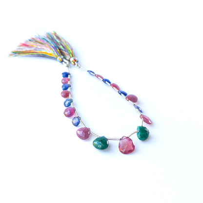 Vibrant Ruby, Blue Sapphire and Emerald briolette stones with radiant shine and elegant faceting.
