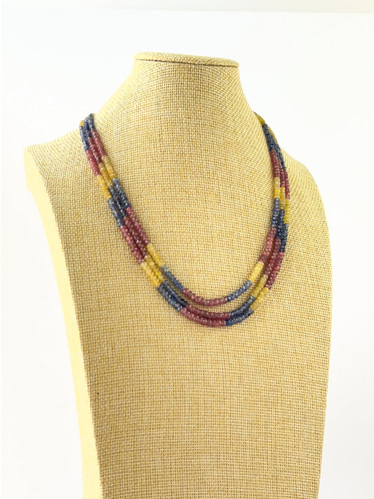 Layered gemstone necklace crafted with faceted rondelle ruby, blue sapphire, and yellow sapphire beads.