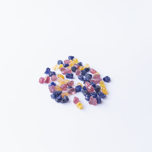 Mixed Ruby, Blue Sapphire and Yellow Sapphire rough stones arranged together with vivid colour contrast.