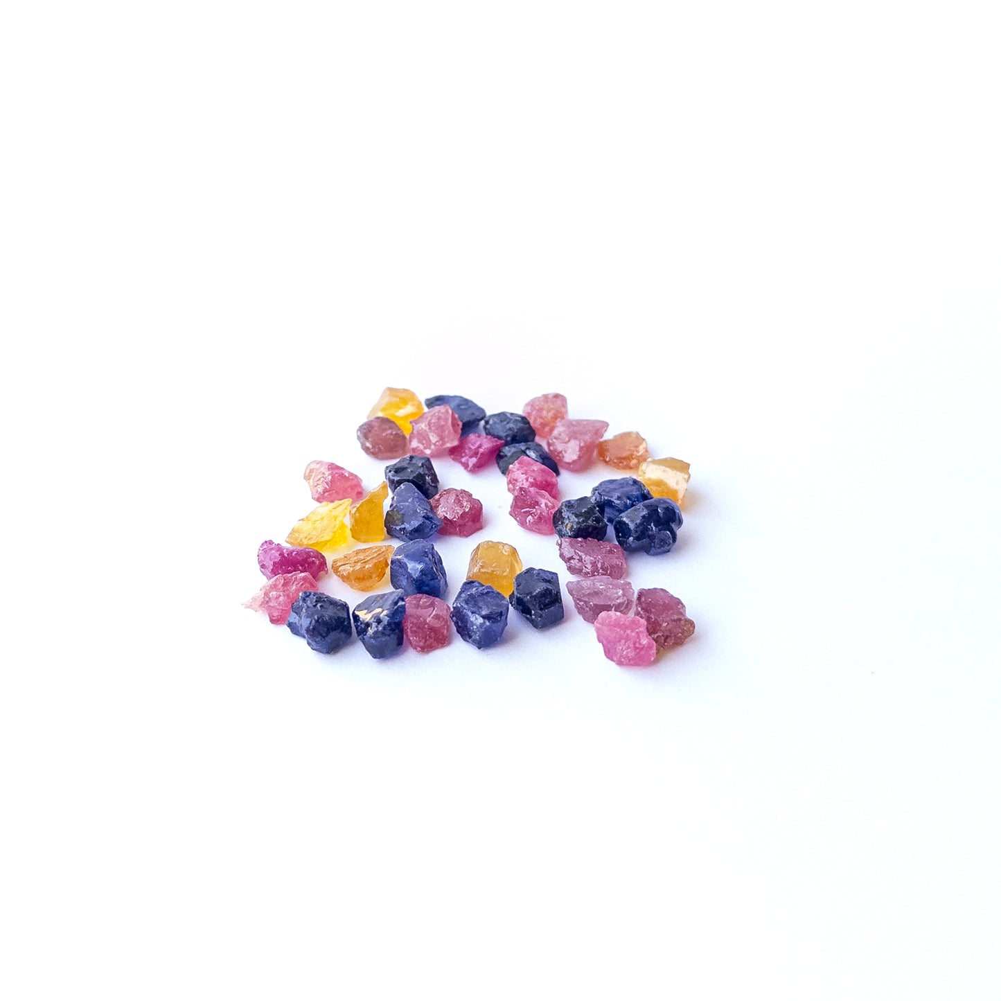 Authentic multi precious rough gemstone pieces featuring vibrant red, blue and yellow tones for jewellery making.