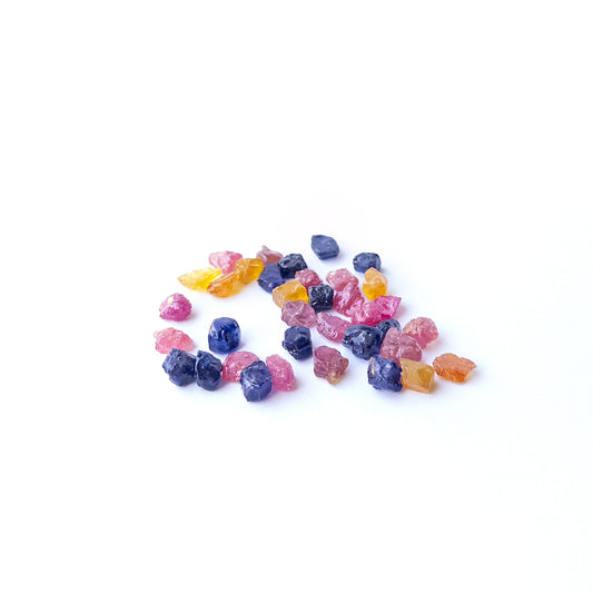 Premium undrilled Ruby, Blue Sapphire and Yellow Sapphire rough stones with raw crystalline surfaces.