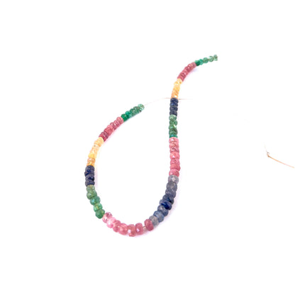 Close‑up of mixed precious gemstone rondelles with polished faceting, ideal for authentic gemstone bead jewellery.