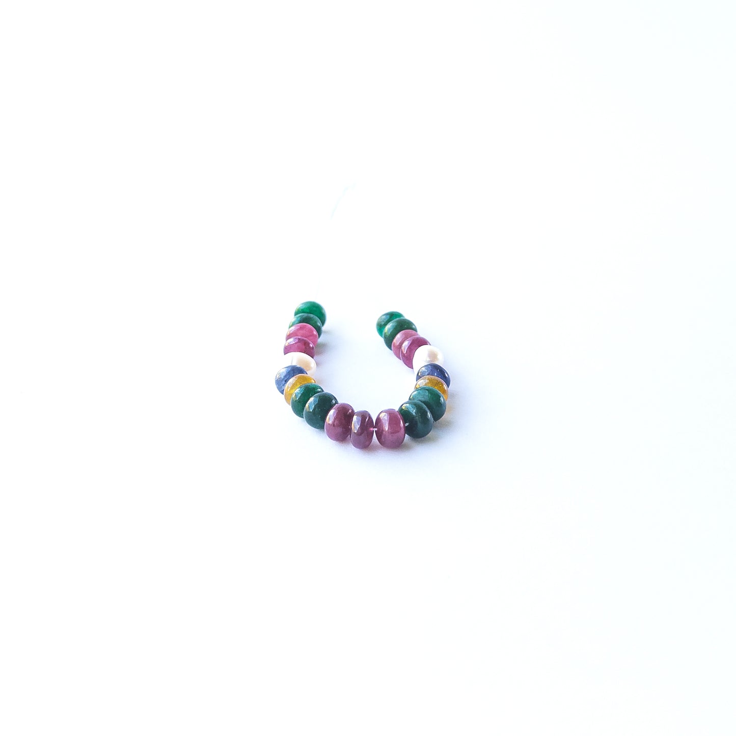 Multi‑precious Ruby, Emerald, Sapphire and Freshwater Pearl smooth rondelle beads arranged in a vibrant strand.