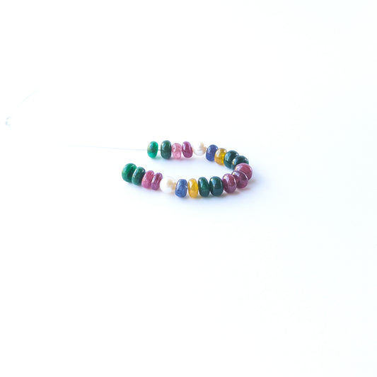 Close‑up of genuine Ruby, Emerald, Sapphire and Pearl rondelle beads showing polished shine and natural gemstone quality.