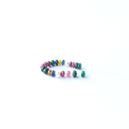 Smooth rondelle Ruby, Emerald, Sapphire and Pearl beads displaying natural colour variation and premium craftsmanship.