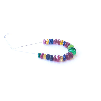 Genuine Ruby, Emerald and Sapphire gemstone beads arranged in a strand for artisan jewellery creators.
