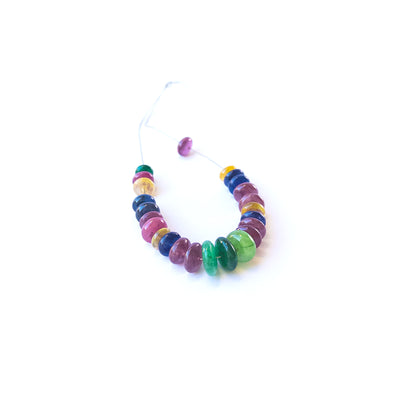 Multi‑precious Ruby, Emerald and Sapphire smooth rondelle gemstone beads arranged in a vibrant strand for handmade jewellery.